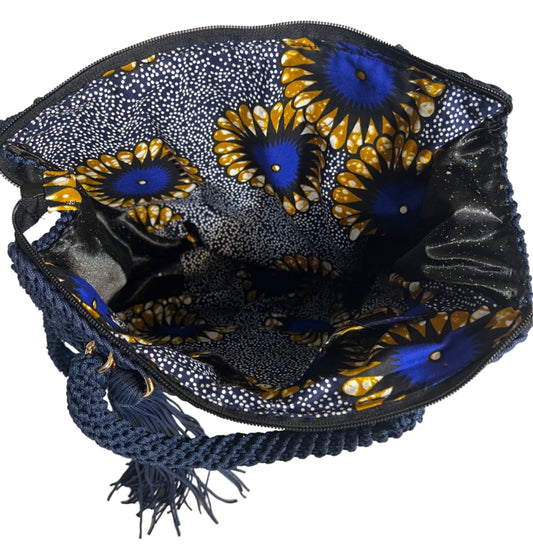 Crochet shoulder bag for women featuring a colorful floral interior and braided strap for stylish convenience