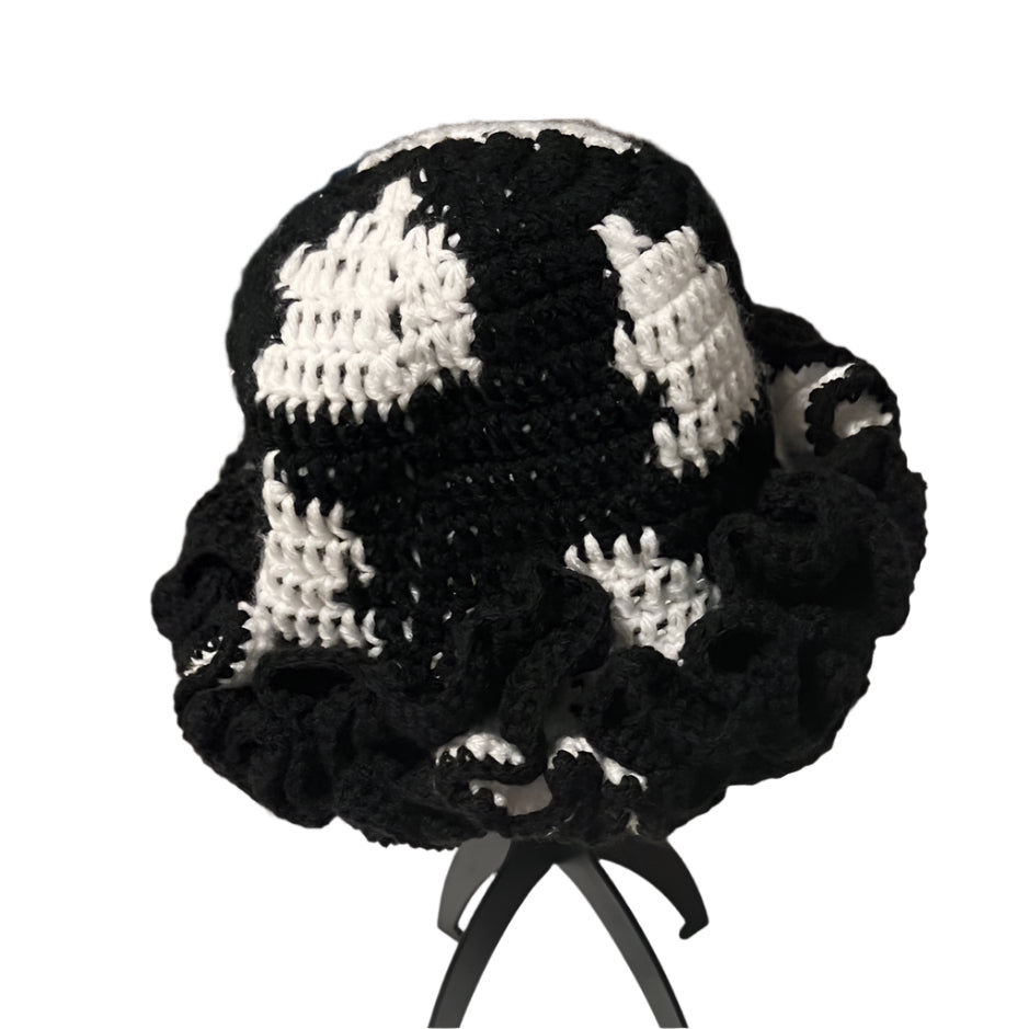 Handmade black and white ruffle hat by ThreadsByHannah with intricate crochet design