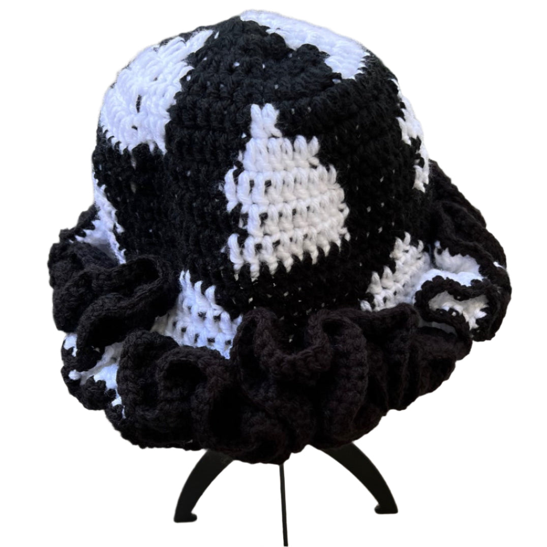 Handmade black and white ruffle hat knitted with a unique textured pattern and ruffled brim