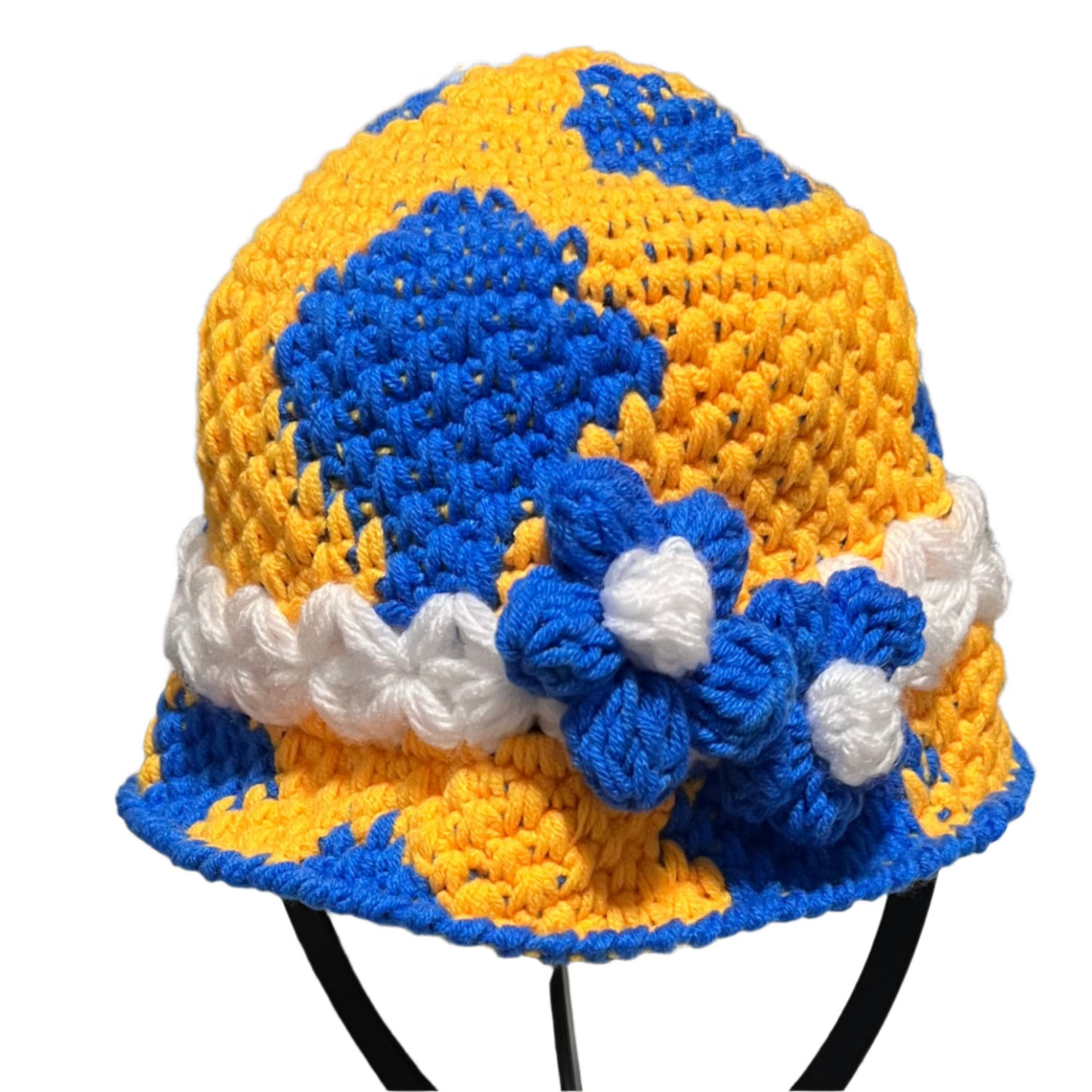 Handmade crochet toddler hat in yellow and blue with white accents and decorative flowers