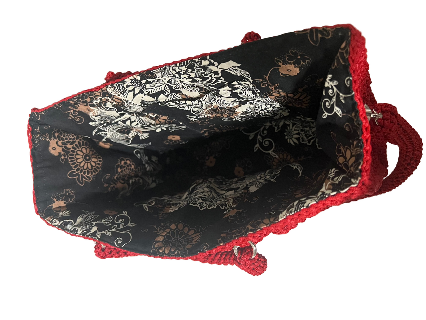 Handmade red Trapezoid handbag with intricate black floral lining and spacious interior