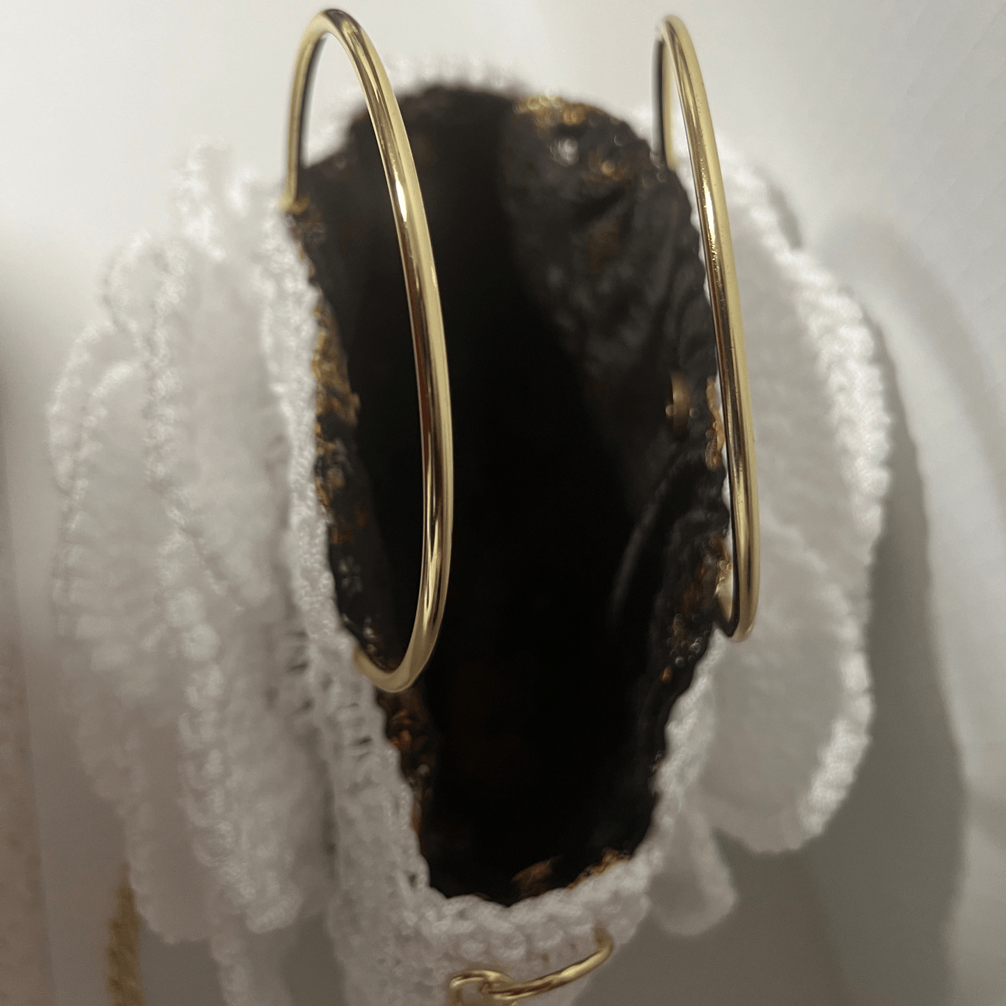 African Handmade Crochet Flower Sling Purse featuring a unique design with gold rings and a textured interior