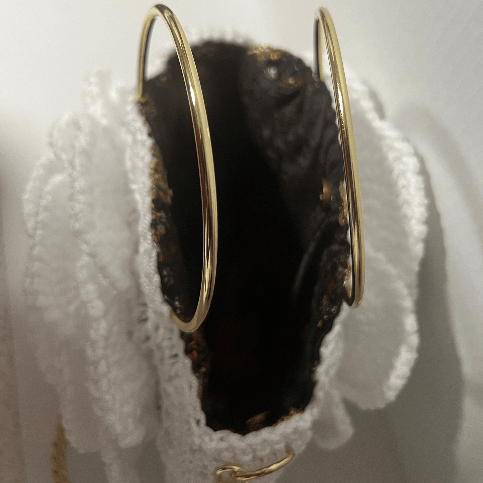 African Handmade Crochet Flower Sling Purse featuring a unique design with gold rings and a textured interior