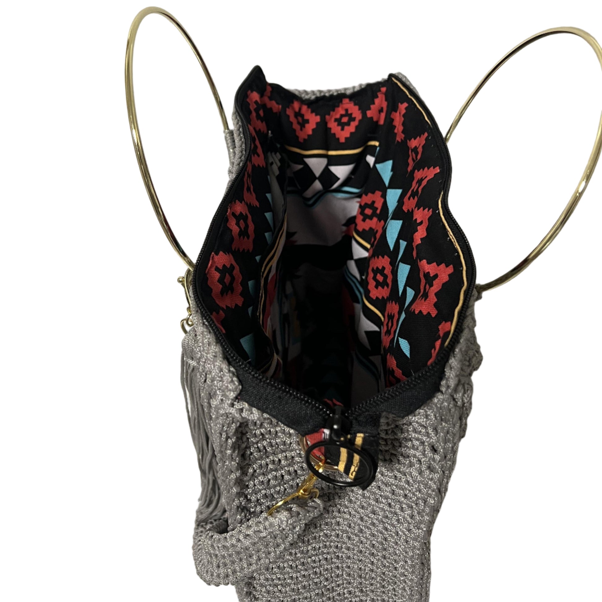 African handmade Trapezoid handbag with vibrant interior patterns and gold handles