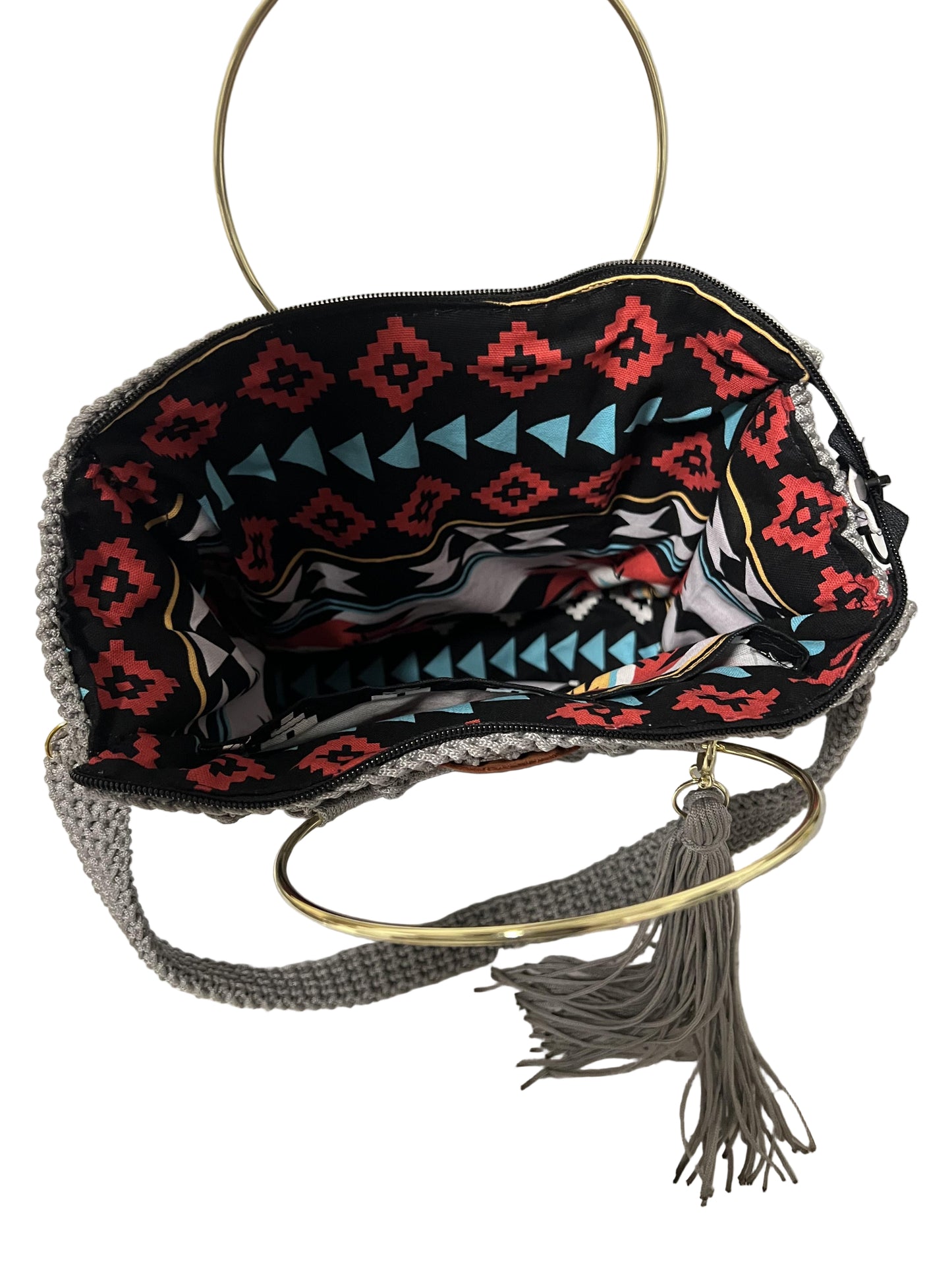 African handmade Trapezoid handbag with colorful interior and stylish gold ring handle