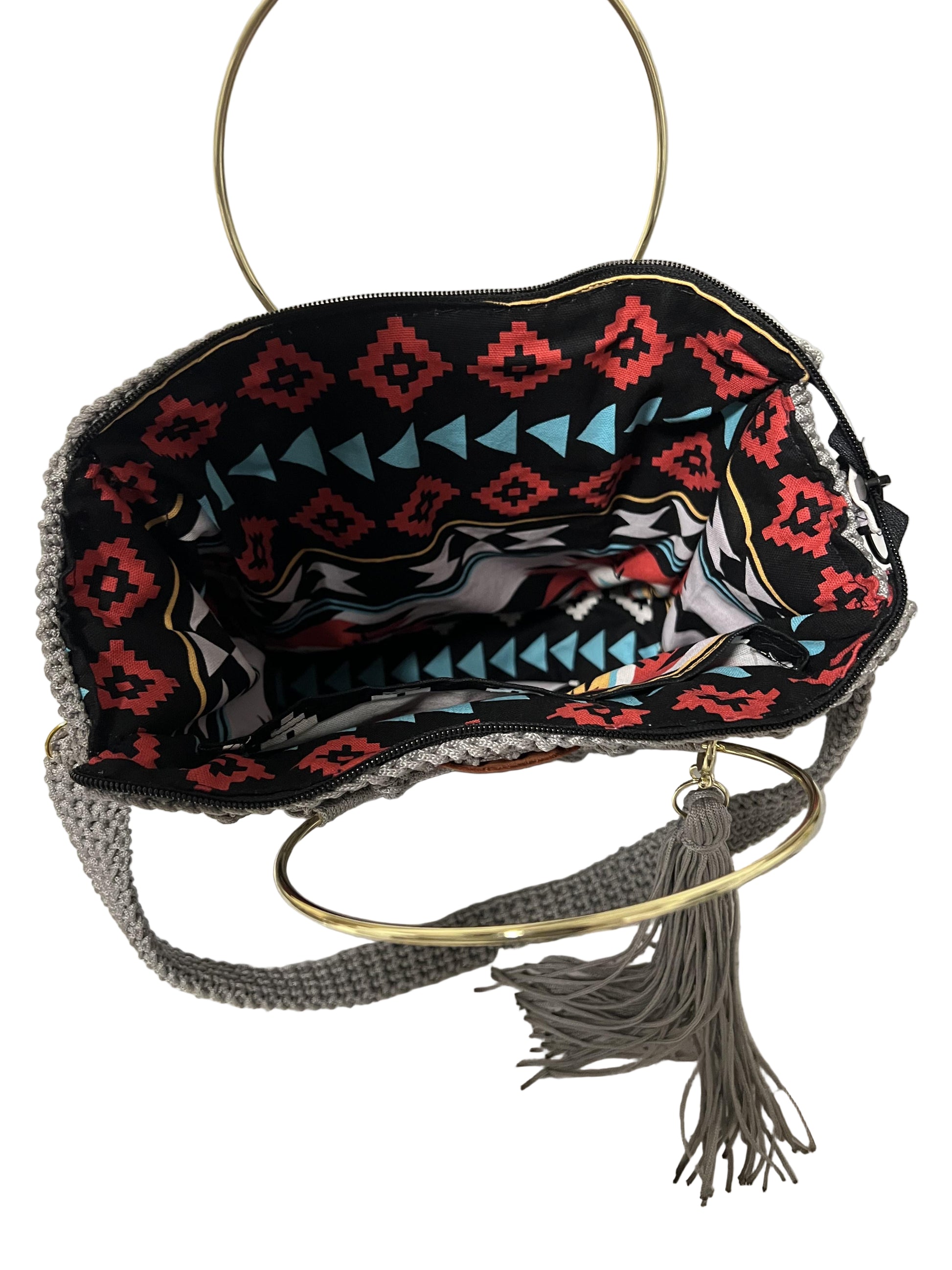 African handmade Trapezoid handbag with colorful interior and stylish gold ring handle