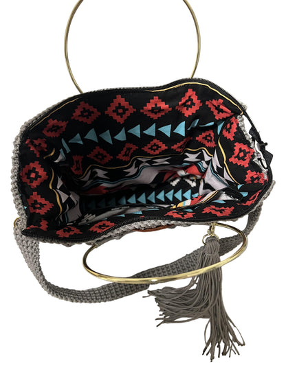 African handmade Trapezoid handbag with colorful interior and stylish gold ring handle