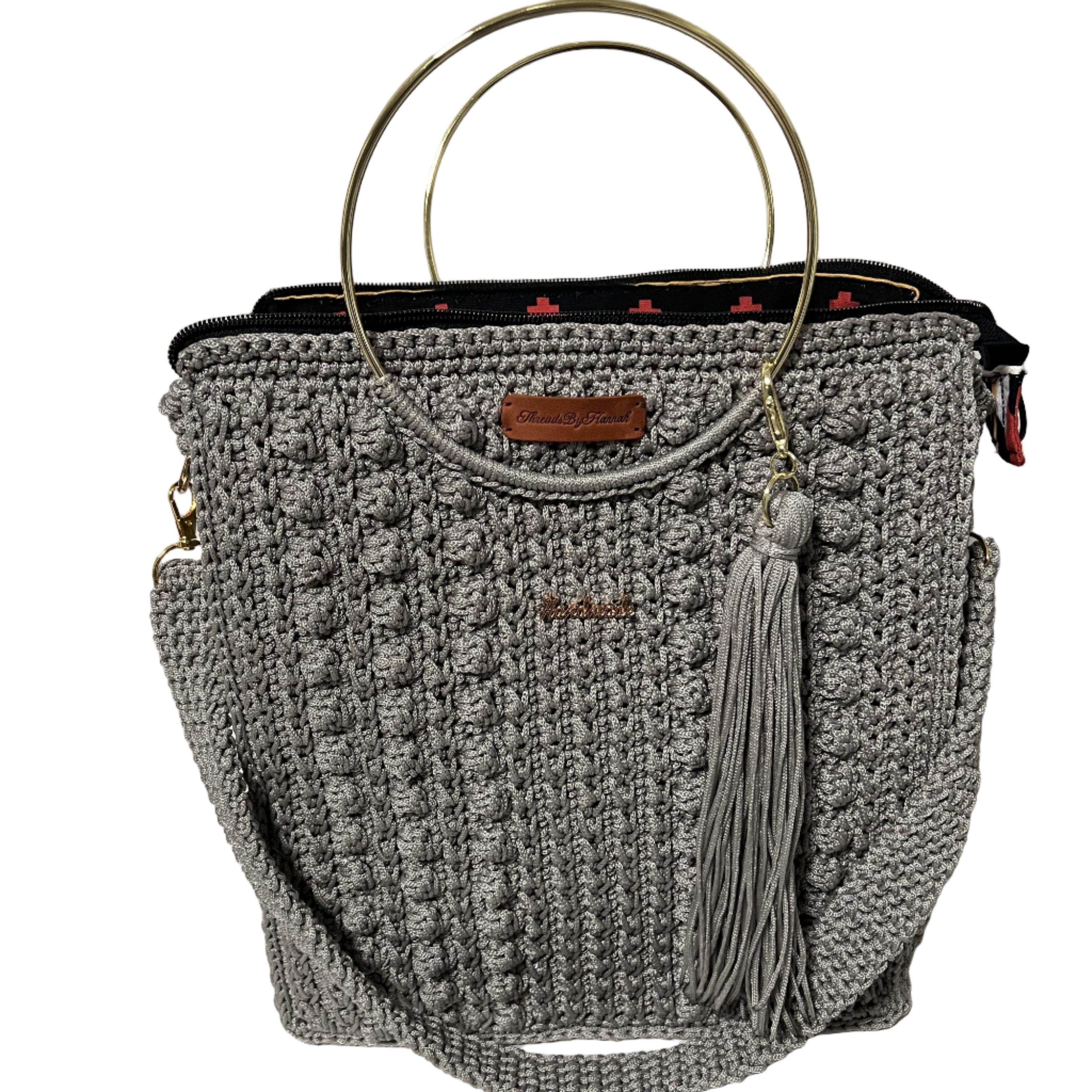 African handmade Trapezoid handbag with a stylish design and gold ring handles