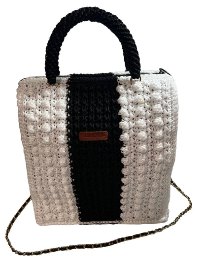 Boho black and white shoulder bag with a stylish trapezoid shape and intricate woven design