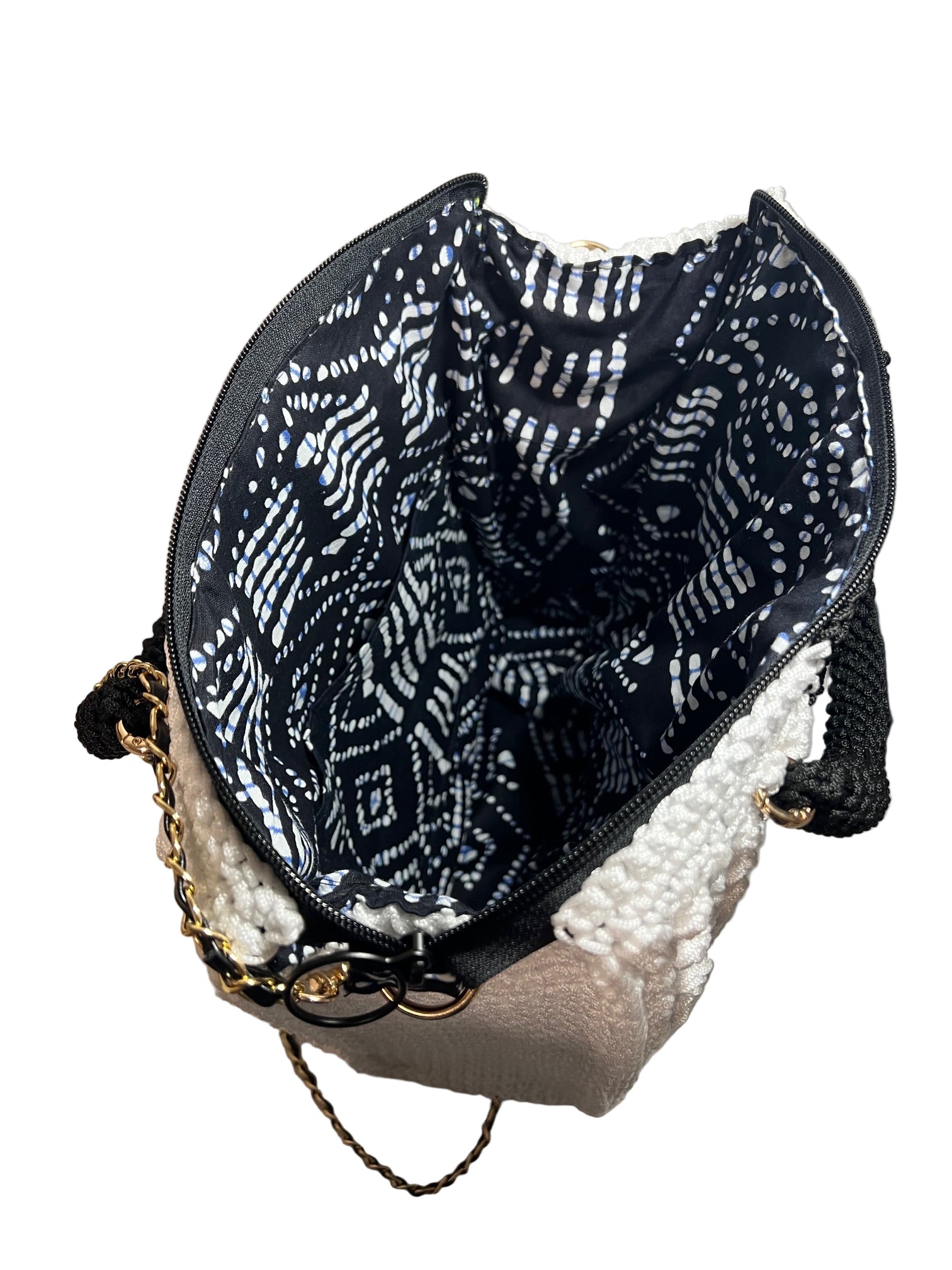Inside view of a boho black and white shoulder bag with stylish patterned lining and zipper closure