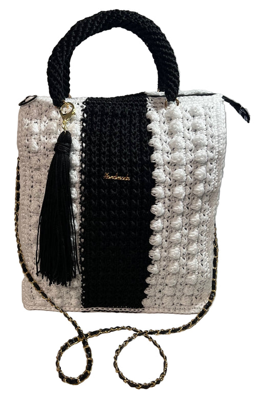 Boho black and white shoulder bag with woven design and detachable tassel accessory