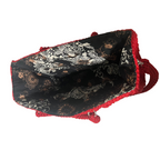 Interior view of Flame Frame Structured Red Trapezoid Bag with floral fabric lining and red braided shoulder strap