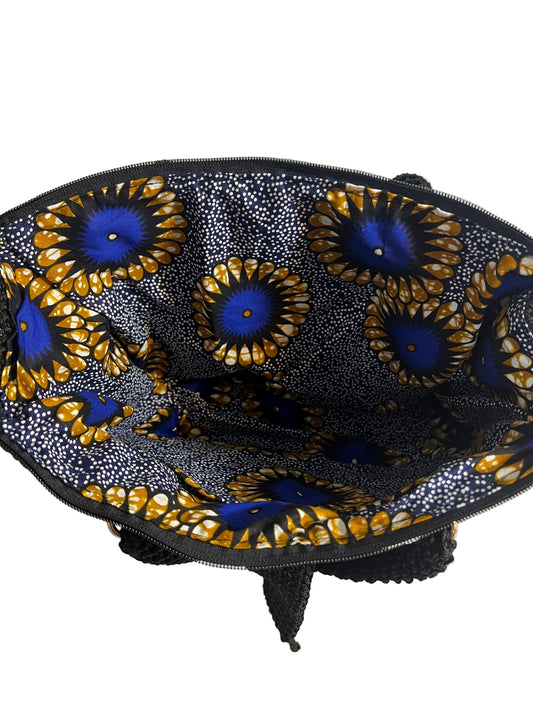 Inside view of a grey crochet shoulder bag for women with vibrant patterned lining