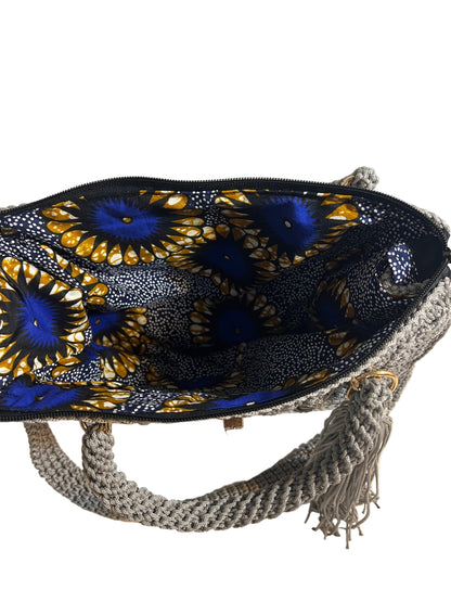 Inside view of grey crochet shoulder bag for women with colorful patterned lining and zipper closure