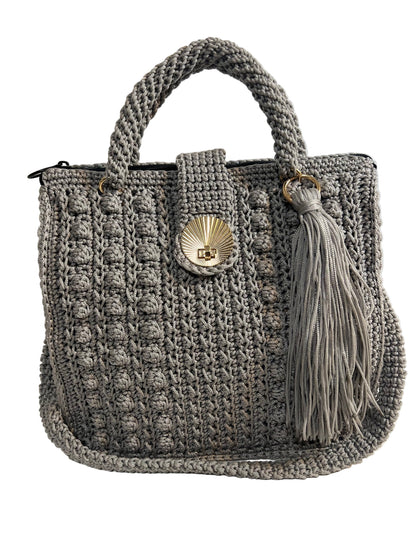 Stylish grey crochet shoulder bag for women with a decorative tassel and unique shell clasp