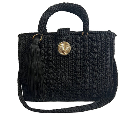 Handcrafted black sling handbag with a textured design and tassel detail for stylish casual outings