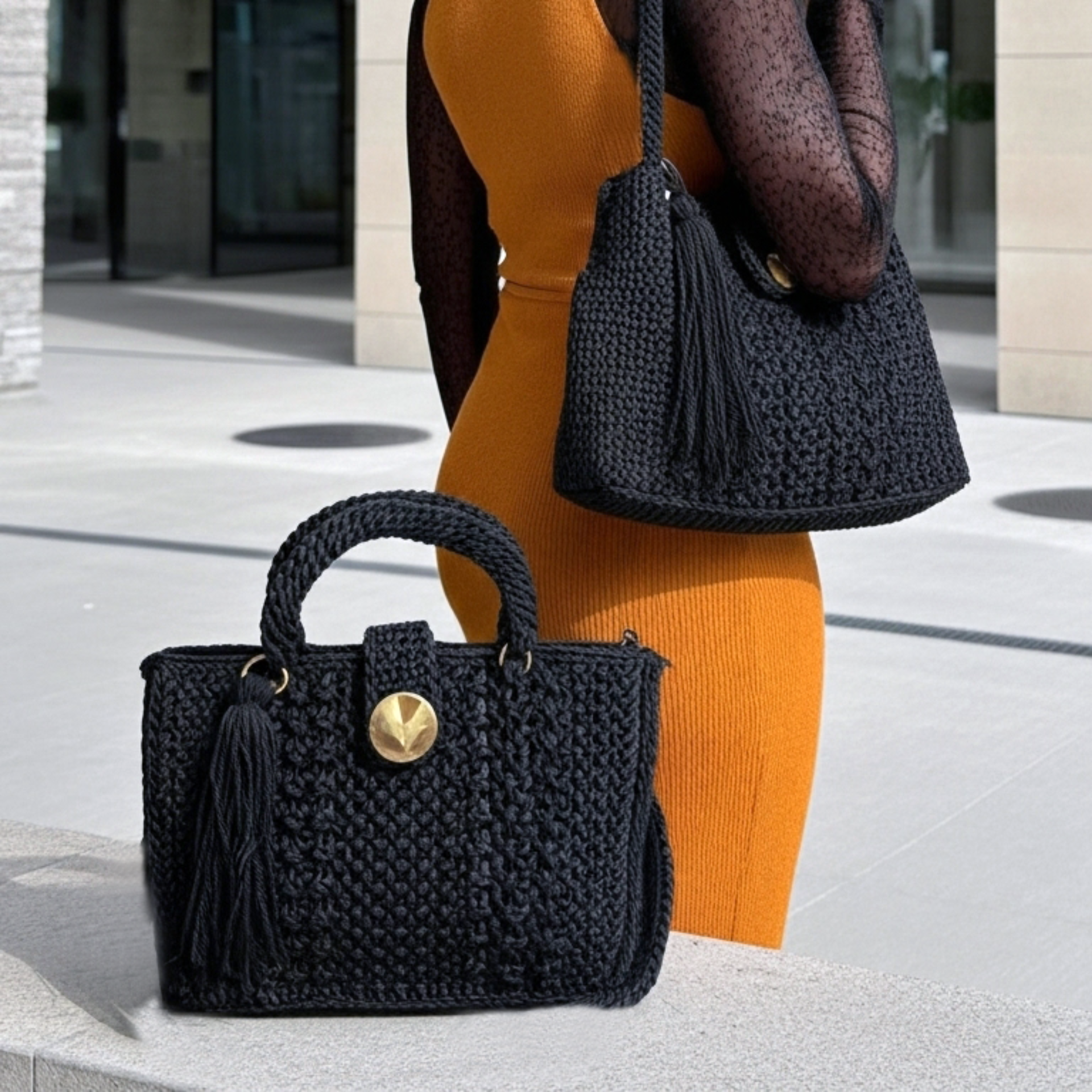 Handcrafted black sling handbag featuring a stylish design and a tassel for a trendy look