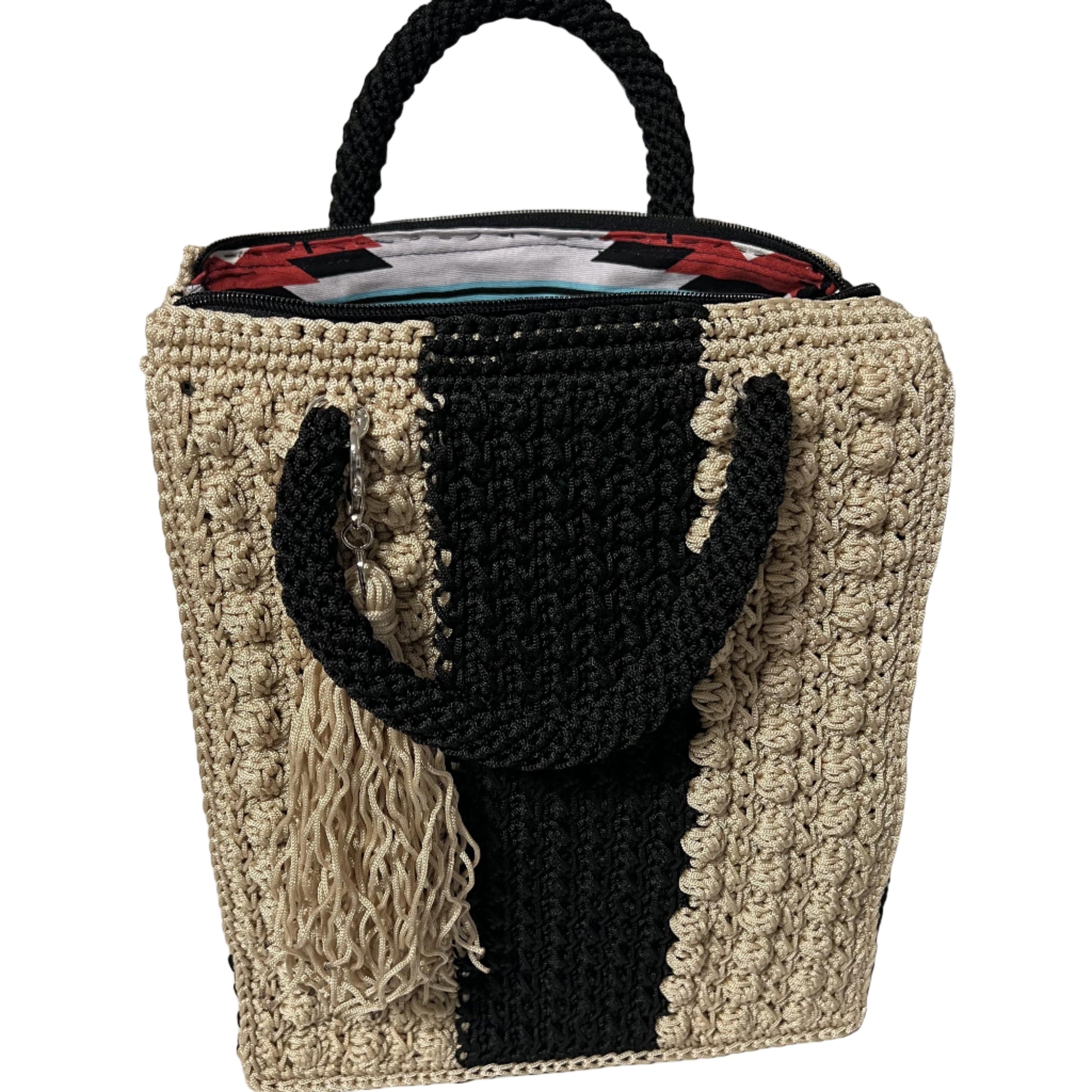 Handcrafted bohemian tote bag with unique patterns and textured handles in neutral tones