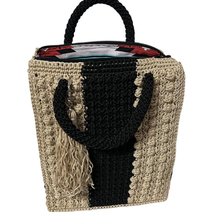 Handcrafted bohemian tote bag with unique patterns and textured handles in neutral tones