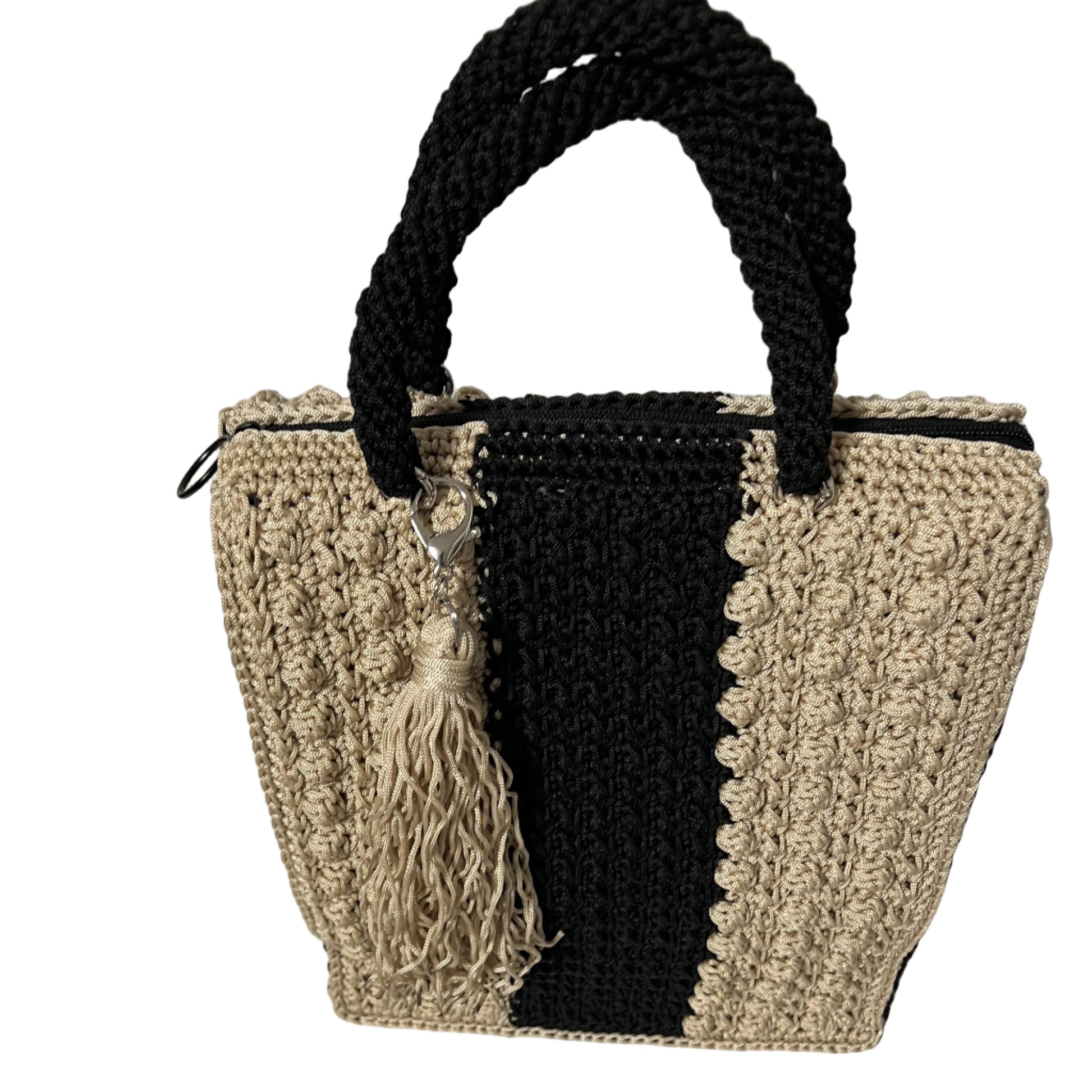 Handcrafted bohemian tote bag with a unique trapezoid shape and braided handle