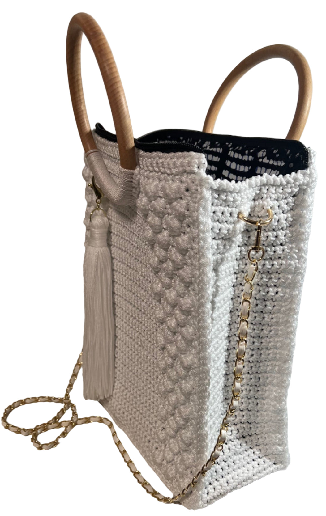 Handcrafted trapezoid handbag with wooden handles and decorative tassel for stylish outings