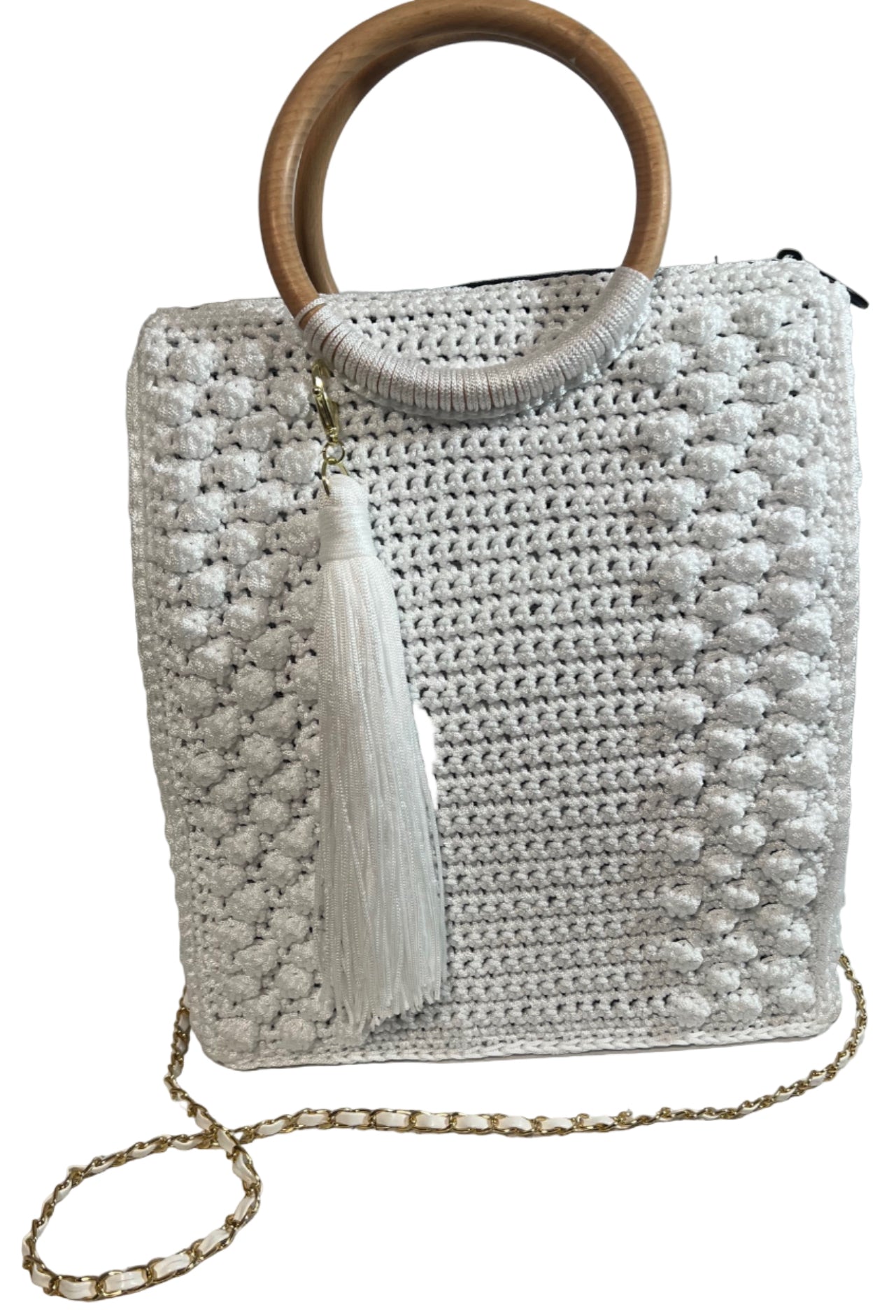 Handcrafted trapezoid handbag in white with wood handle and tassel detail for stylish accessorizing