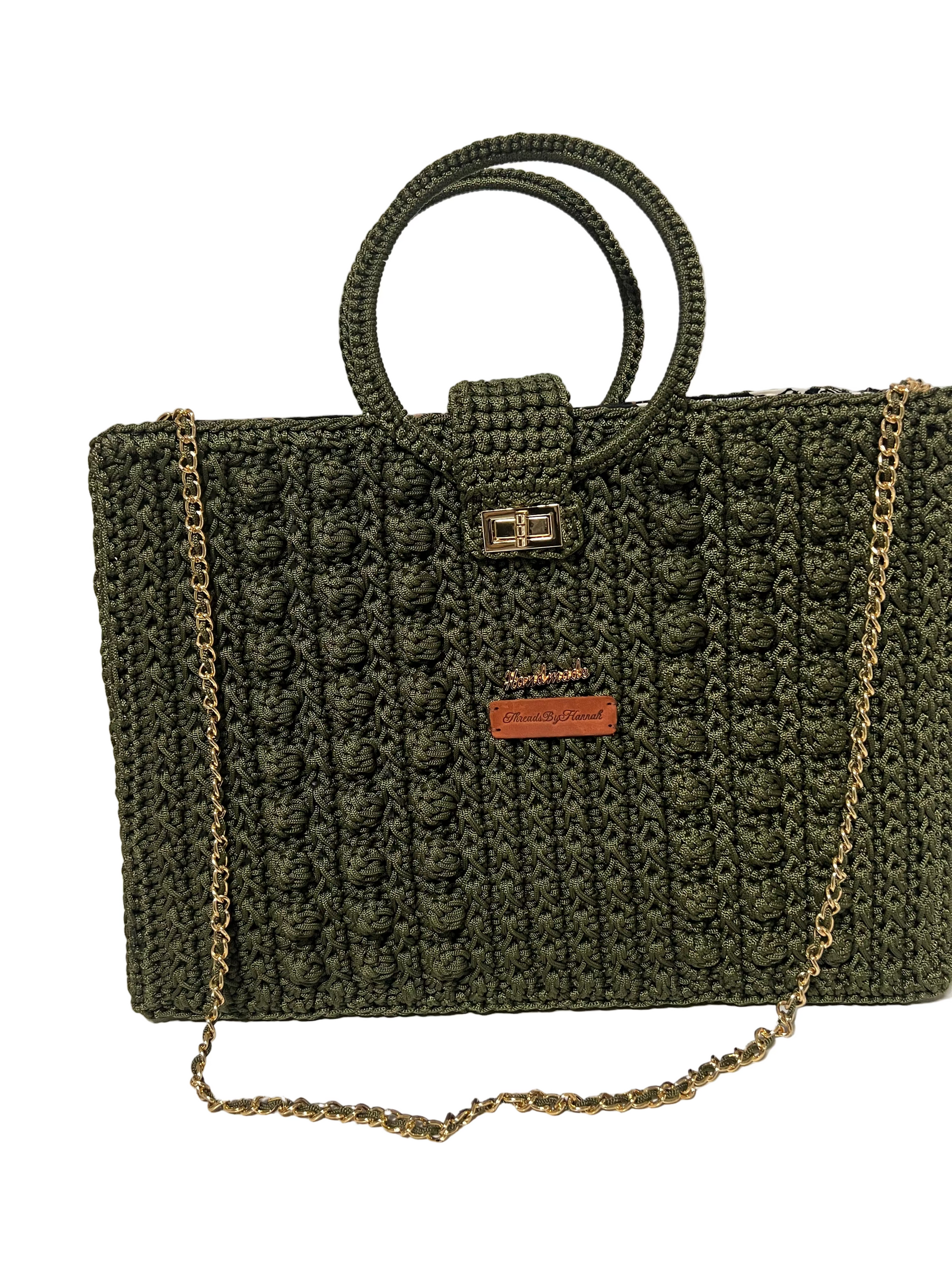 Handcrafted trapezoid handbag with chain in dark green with textured pattern and circular handles