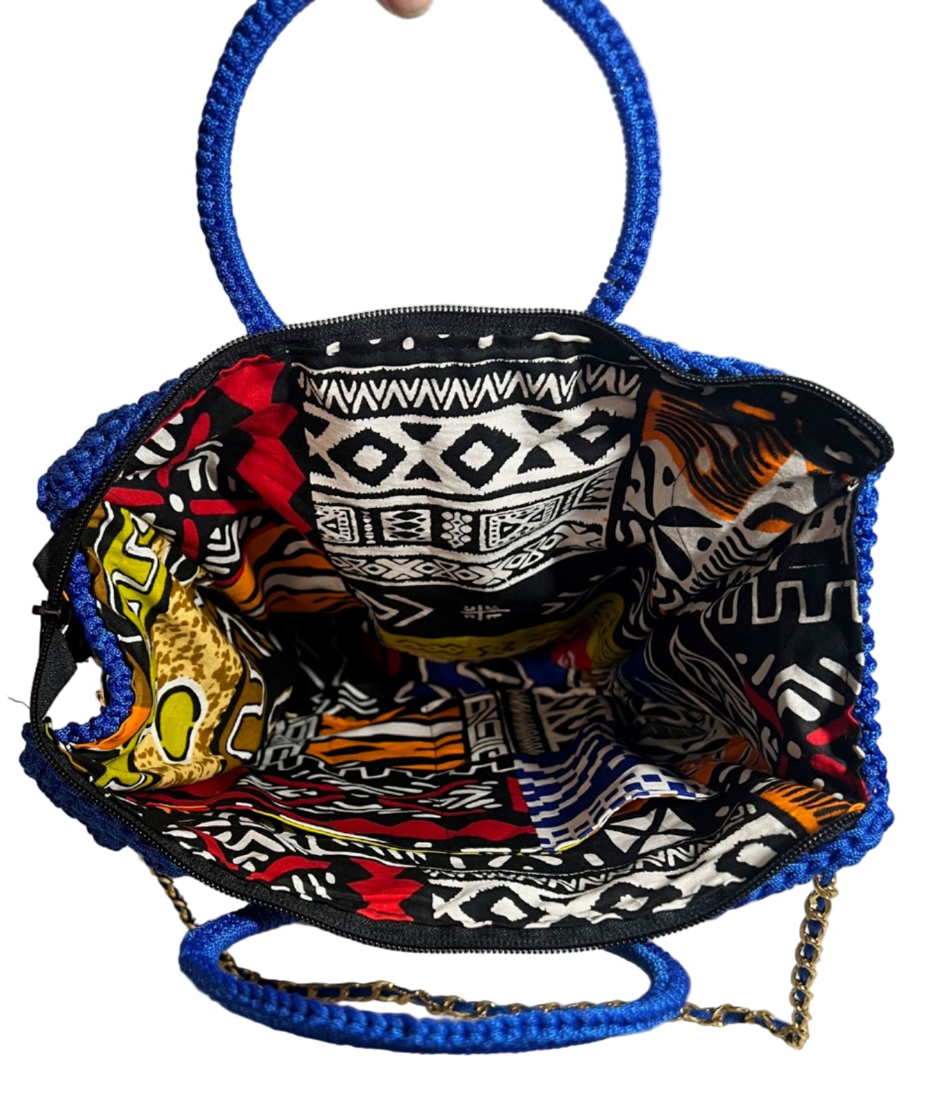Interior view of a handmade blue African print handbag showing vibrant patterns and spacious design