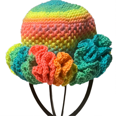 Handmade crochet toddler ruffle hat in vibrant rainbow colors with multicolored ruffles