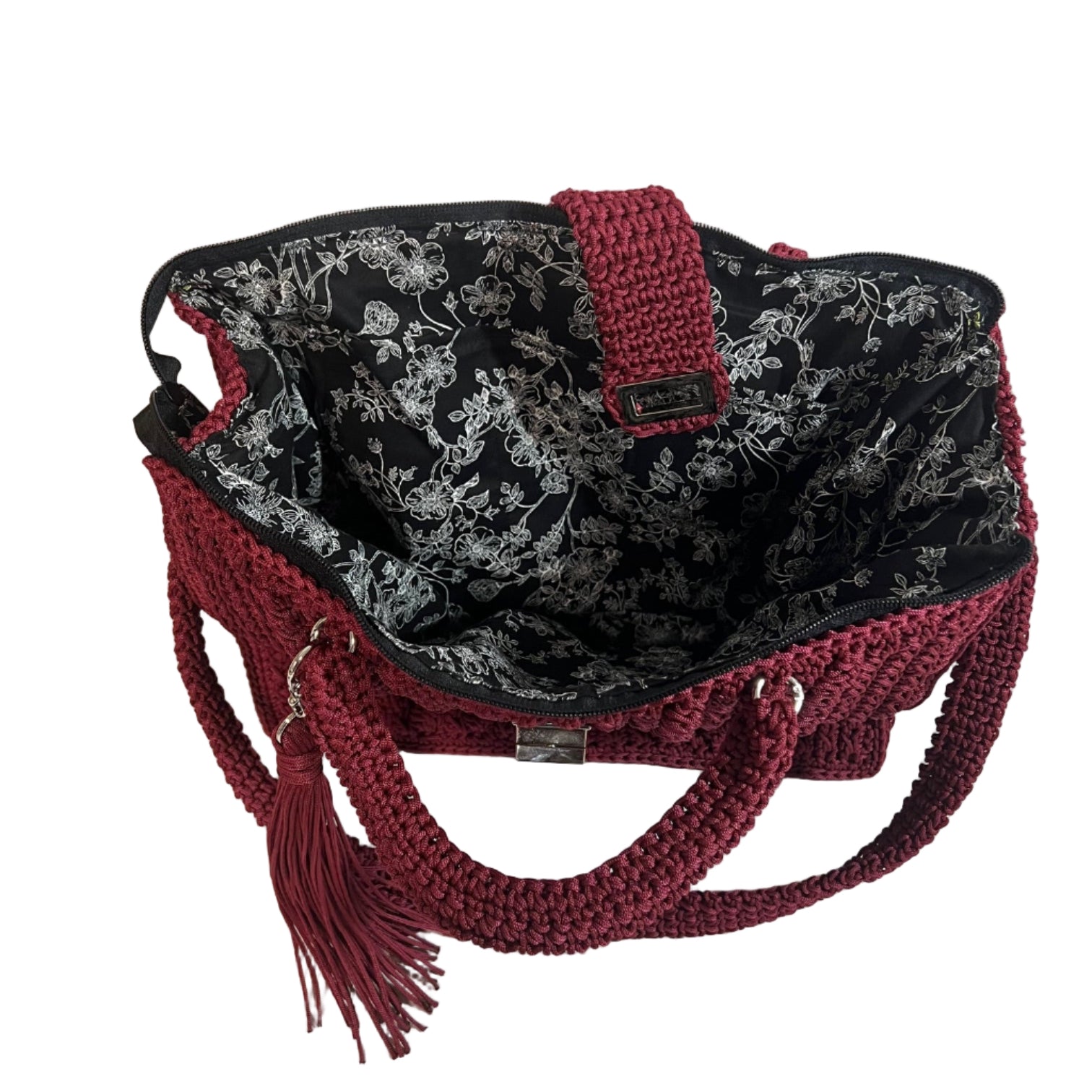 Handmade red sling handbag with intricate crochet design and floral lining for stylish storage