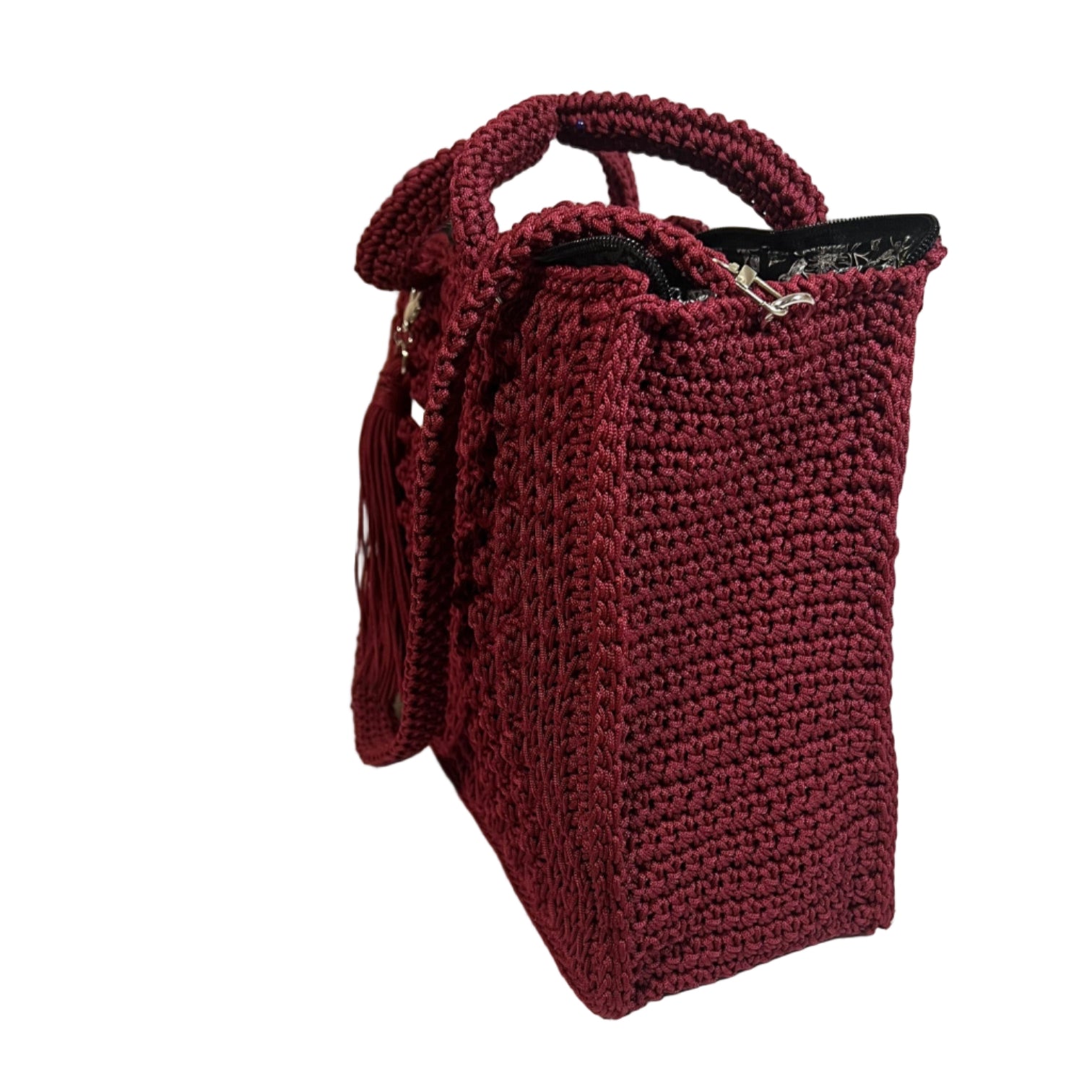Handmade red sling handbag with a textured crochet design and stylish tassel detail