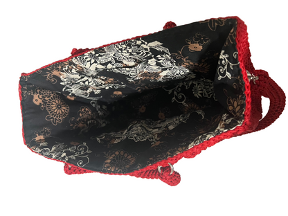 Handmade red Trapezoid handbag with intricate black floral lining and spacious interior