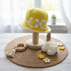 Little Sunshine Baby Crochet Hat in yellow with white and yellow flower details displayed on a wooden stand