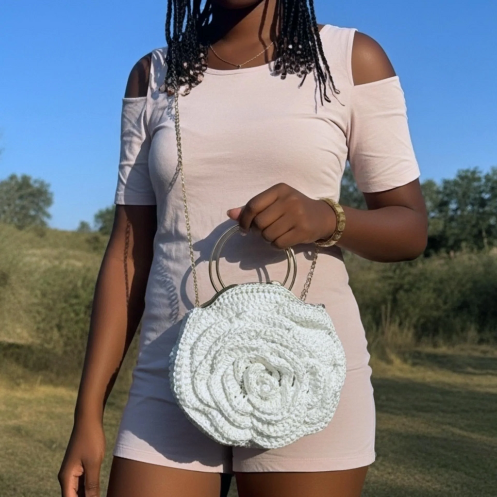 Petals Tradition African Crochet Flower Purse crossbody in white worn by woman in light pink dress