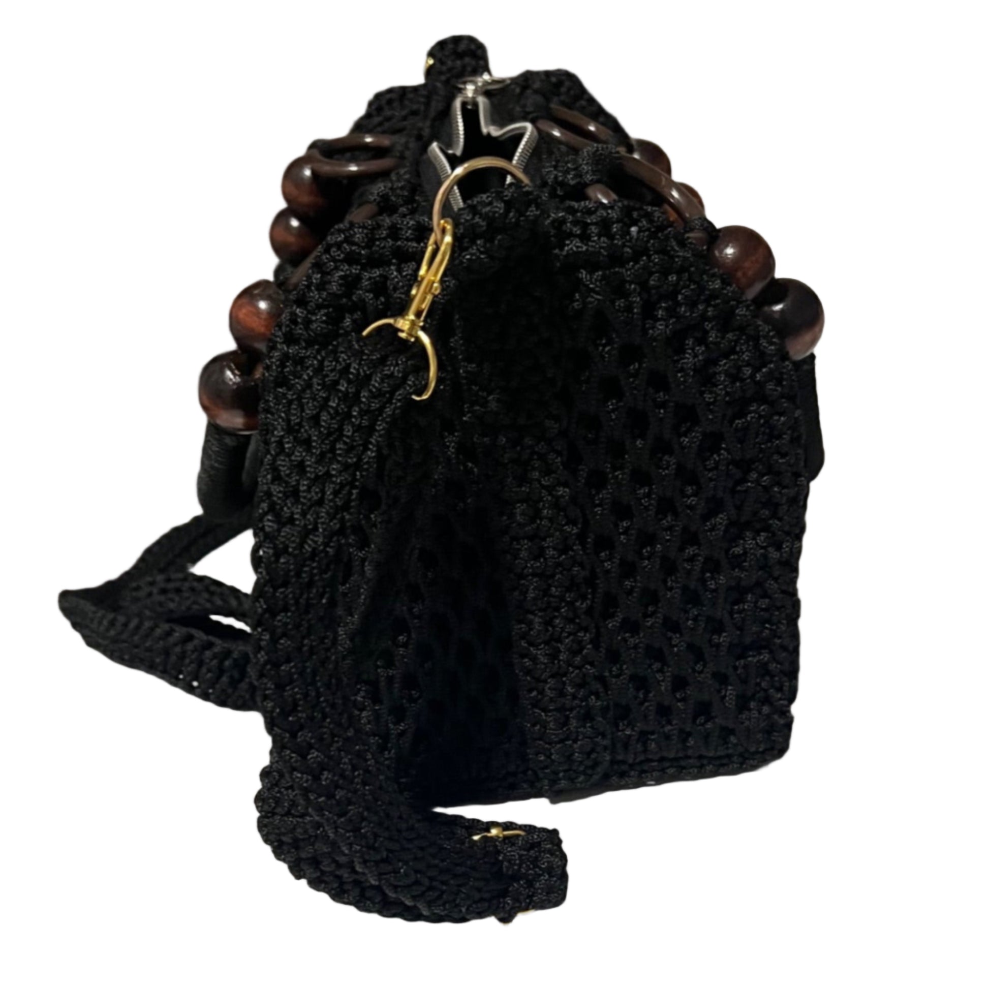 Black African handmade crochet handbag by ThreadsByHannah with wooden bead handle and adjustable shoulder strap