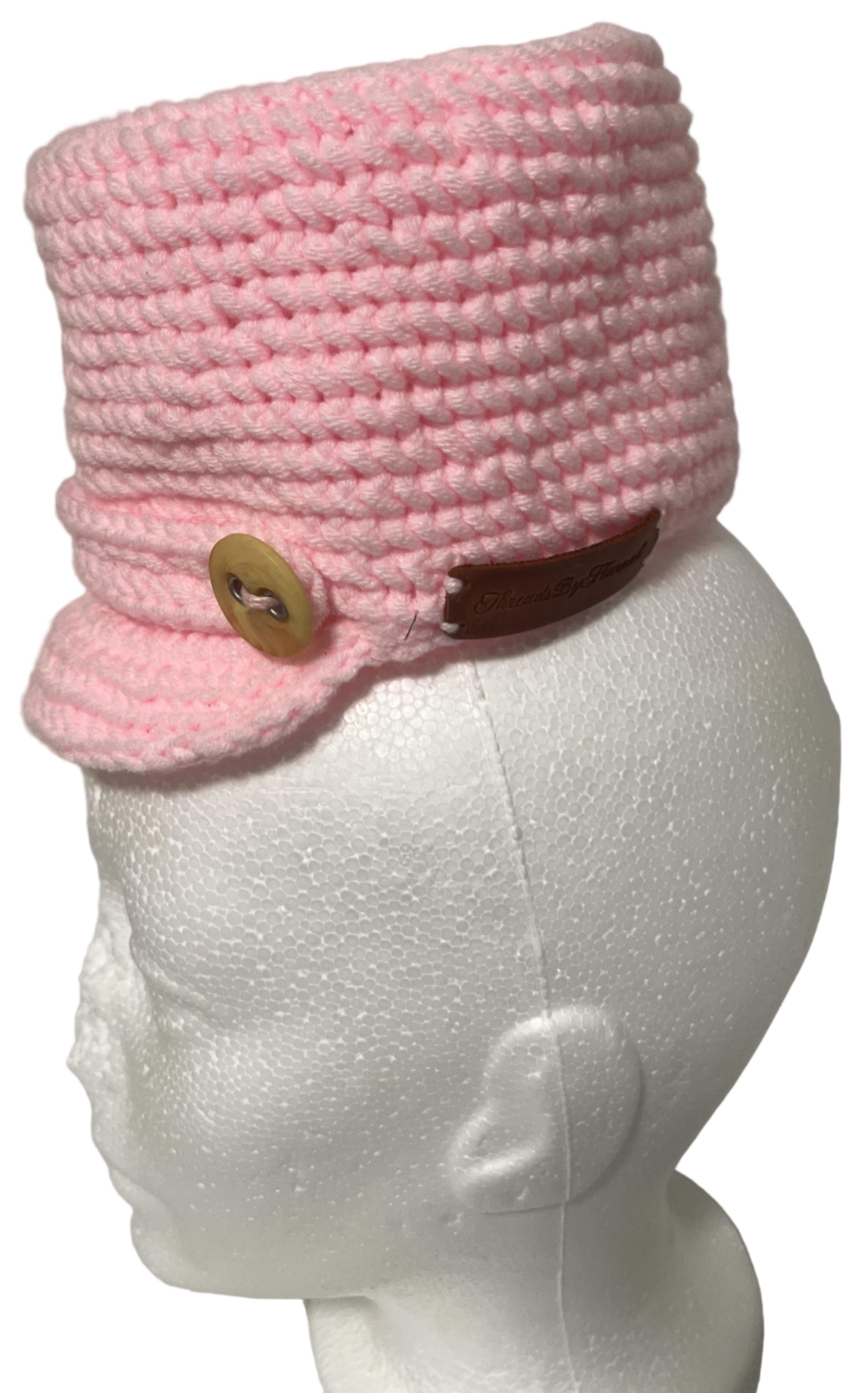 Unique handmade kids winter hat in pink with a stylish brim and wooden button detail