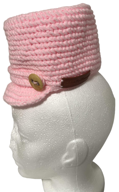 Unique handmade kids winter hat in pink with a stylish brim and wooden button detail