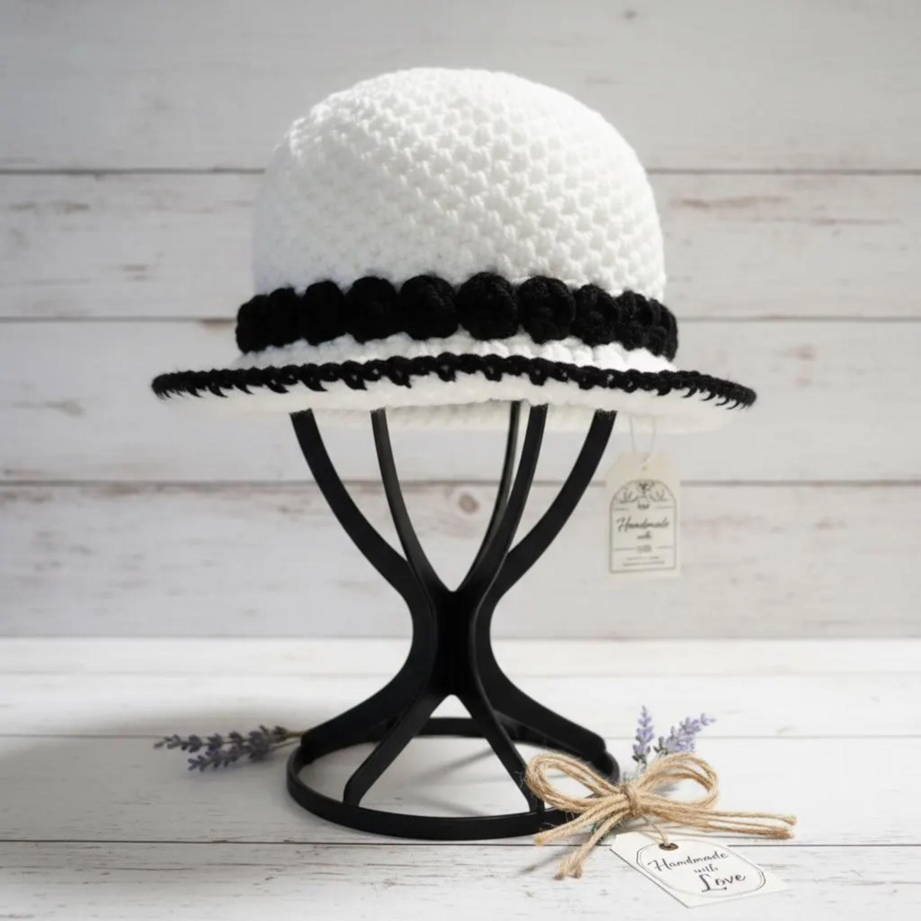 ThreadsByHannah Urban Weave Handmade Monochrome Bucket Hat in white with black trim on a display stand